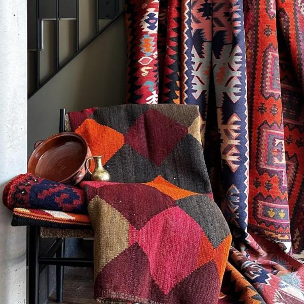Handwoven kilim rugs with geometric patterns in warm colours