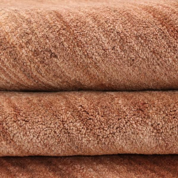 Gabbeh rug in coral colour, folded