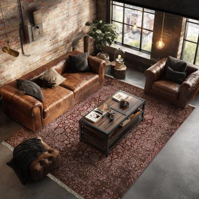 Modern rug Sadraa with oriental pattern under a leather sofa seating group in the living room